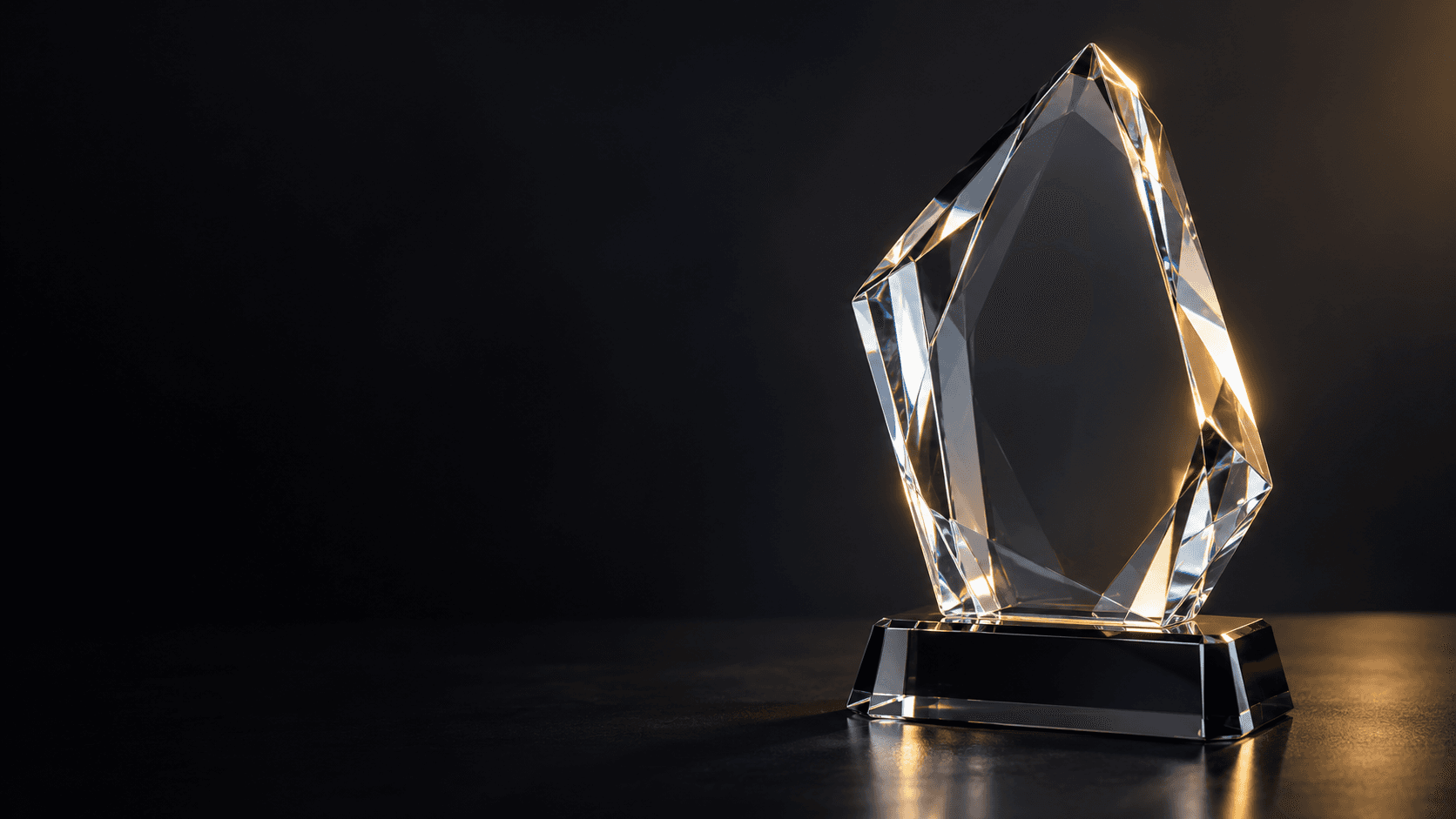 Sculptural optical crystal award in warm studio light