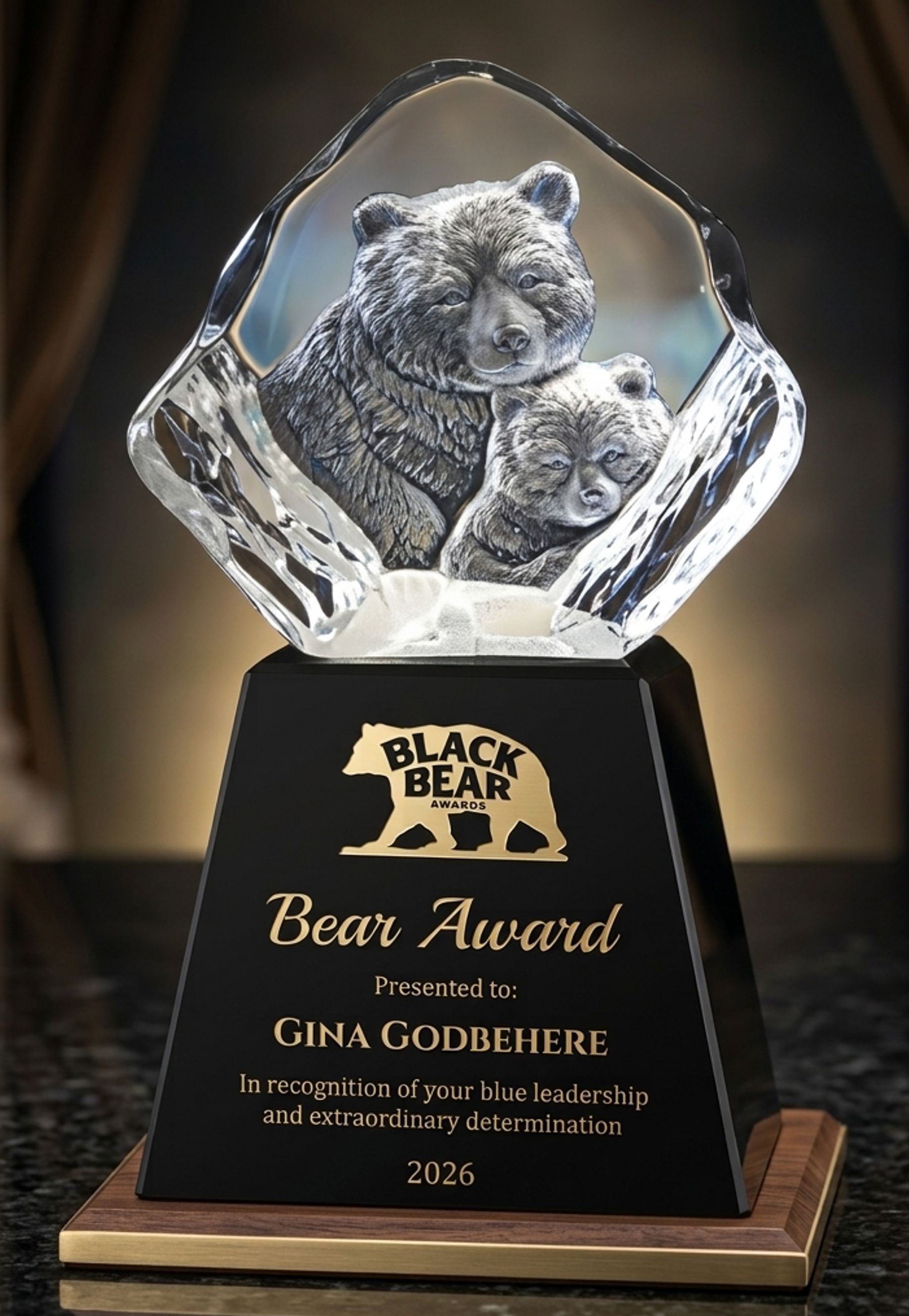 Bear engraved in crystal with warm gold lighting on black base