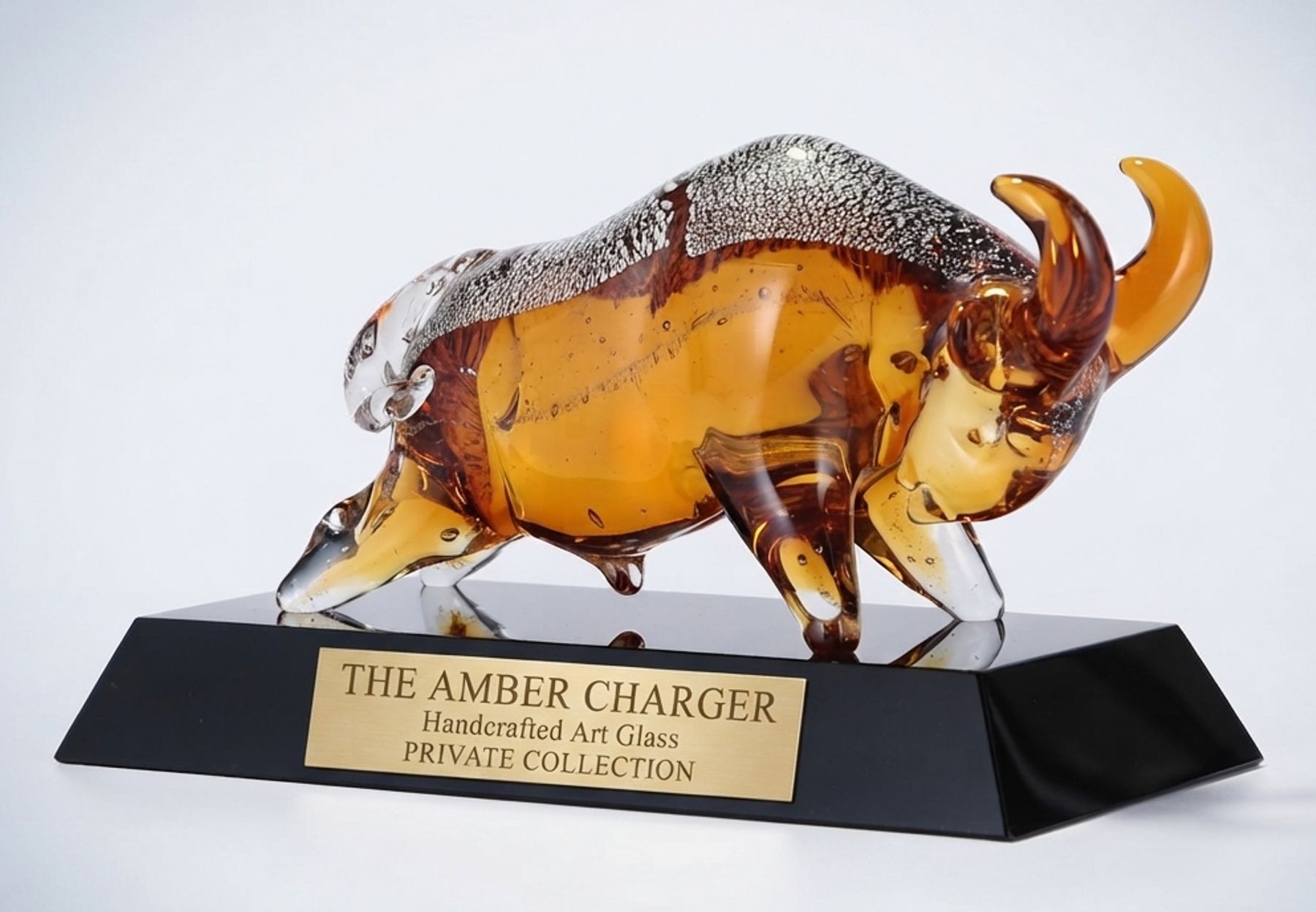 Amber art glass bull sculpture on black base, hand-crafted bull award