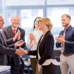 Employees congratulating their leader