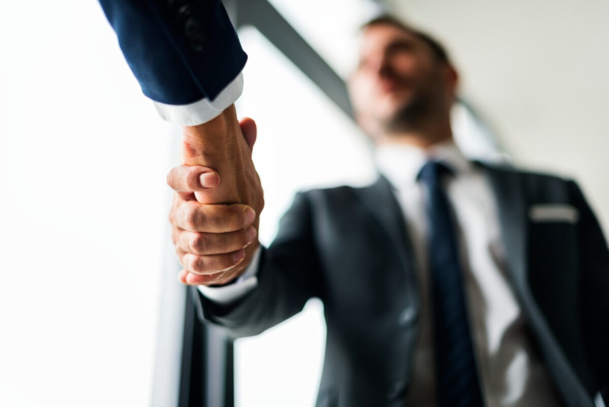 Handshaking between 2 office workers