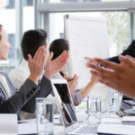 Employees giving a round of applause for their colleague
